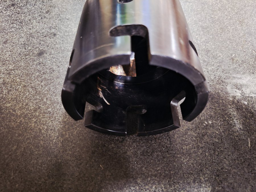 Castellated tubular component with a black oxide finish