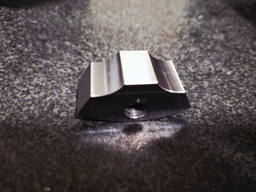 Machined saddle block with a tapped hole